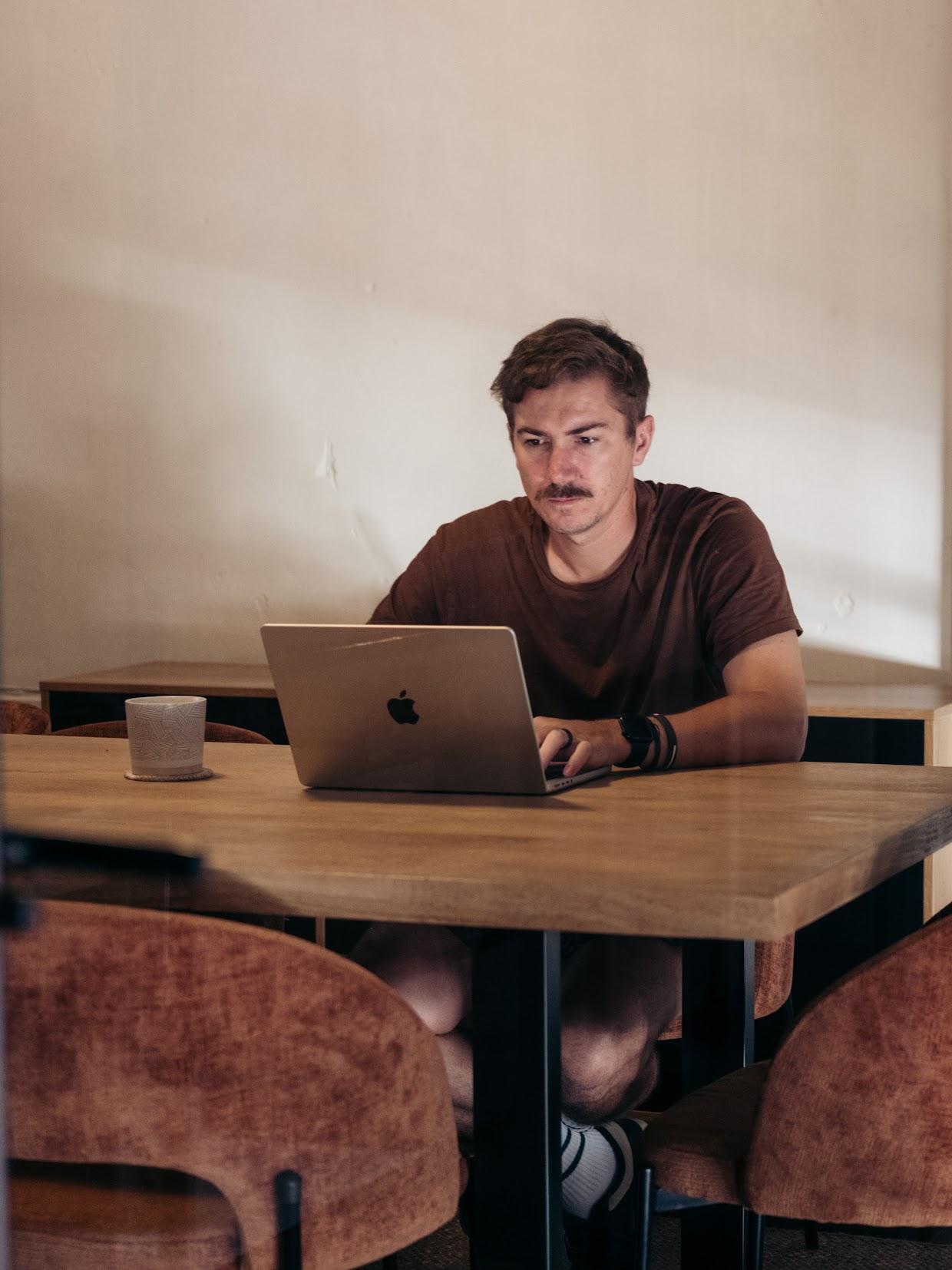 A team member working heads-down with coffee